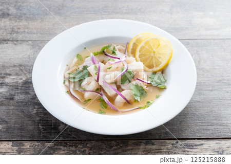 Traditional Peruvian ceviche sea bass fillet on wooden table 125215888