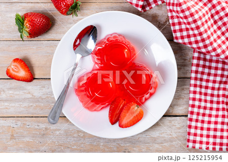 Closeup of strawberry gelatin of on wooden table 125215954