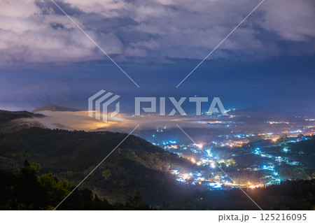 Mystical Spring Night: Mist and Lights in Yuchi's Mountain Forest. 125216095