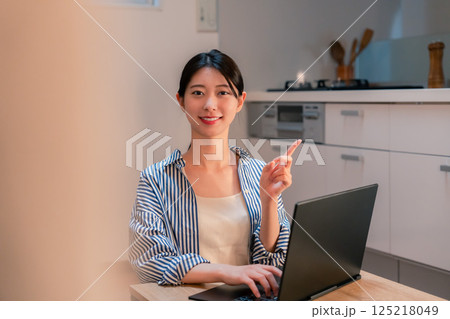 夜遅くまで在宅勤務をする若い女性 125218049