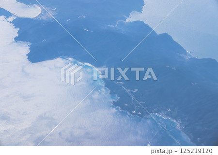View of a Serene Coastal Island Surrounded by Blue Ocean 125219120