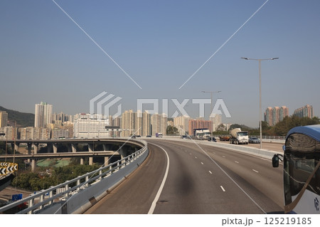 March 22 2025 Highway with Scenic Hillside and Residential Buildings in Modern Urban Landscape 125219185