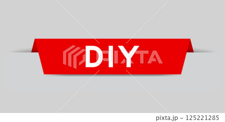 Red color inserted label with word DIY (abbreviation of do it yourself) on gray background 125221285