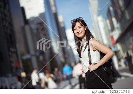 Tokyo success, A successful Japanese businesswoman in her 30s, portraying a dynamic and confident urban lifestyle in Tokyo. 125221736