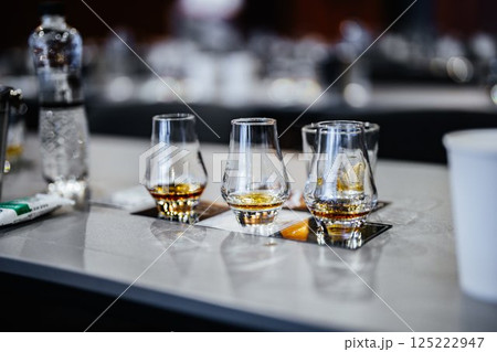 Whiskey tasting experience at a modern bar during evening gathering Whiskey tasting experience at a modern bar during evening gathering 125222947
