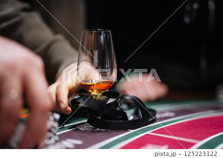 Whiskies shared among friends during tense moments at the casino table Whiskies shared among friends during tense moments at the casino table 125223122