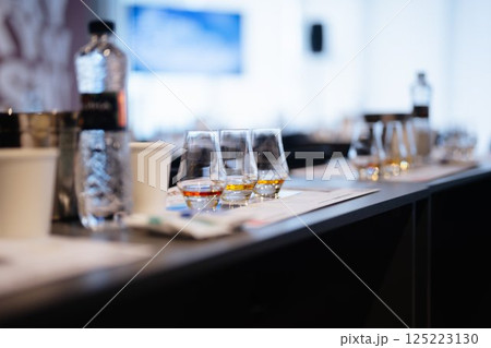 Tasting session featuring a variety of spirits and refreshments at a conference 125223130