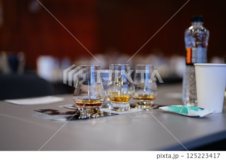 Enjoying fine whiskey samples at a tasting event in an elegant setting Enjoying fine whiskey samples at a tasting event in an elegant setting 125223417