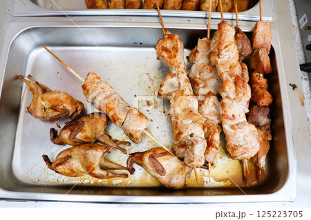 Delicious Grilled Meat Skewers paired with Roasted Quail served elegantly on a Food Tray Delicious Grilled Meat Skewers paired with Roasted Quail served elegantly on a Food Tray 125223705