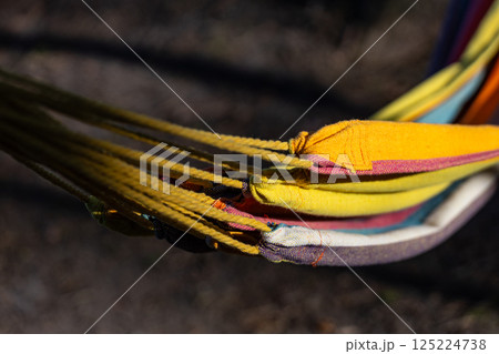 Colorful Hammock String Details Highlighting Texture and Fabric Patterns for a Relaxing Outdoor Experience in Nature's Embrace 125224738