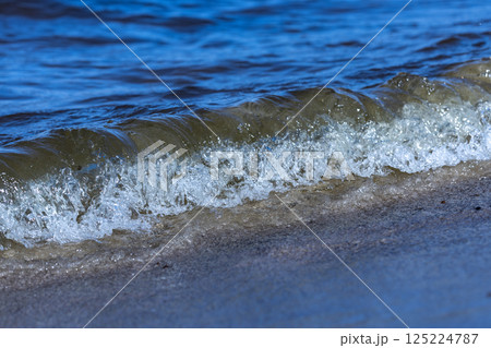 A Glorious Wave Crashing on the Shoreline: Capturing the Essence of Nature's Beauty and the Serenity of the Sea in a Single Moment A Glorious Wave Crashing on the Shoreline: Capturing the Essence of Nature's Beauty and the Serenity of the Sea in a Single Moment 125224787