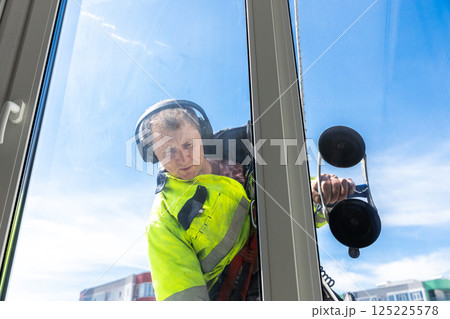 Professional Window Cleaner Working on a High-Rise Building, Ensuring Crystal Clear Glass and Safety While Maintaining Attention to Detail and Quality for Client Satisfaction Professional Window Cleaner Working on a High-Rise Building, Ensuring Crystal Clear Glass and Safety While Maintaining Attention to Detail and Quality for Client Satisfaction 125225578