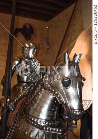 Paladin with joust and shiny medieval armor on horseback with armor. Paladin with joust and shiny medieval armor on horseback with armor. 125226462