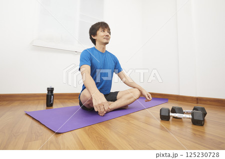 Man Stretching at Home. Man Doing Exercises at Home. Home Workout. Man Doing Sports at Home. Home Sport, Healthy Life, Quarantine Concept 125230728