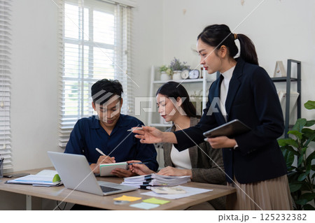 Strategic Planning and Discussion. A team collaborates on a project, analyzing important details and making decisions together. Strategic Planning and Discussion. A team collaborates on a project, analyzing important details and making decisions together. 125232382