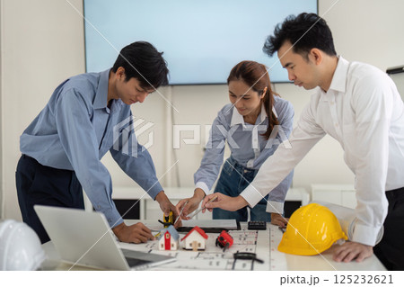 Collective Teamwork in Home Design. Professionals collaborating on architectural concepts and hands-on application. Collective Teamwork in Home Design. Professionals collaborating on architectural concepts and hands-on application. 125232621