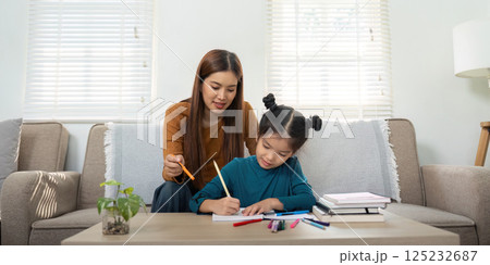 Creativity and Connection. A mother assists her daughter with schoolwork. Creativity and Connection. A mother assists her daughter with schoolwork. 125232687