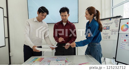 Design Workshop and Interactive Learning. Team members exchanging wireframe ideas in a productive environment. Design Workshop and Interactive Learning. Team members exchanging wireframe ideas in a productive environment. 125232712