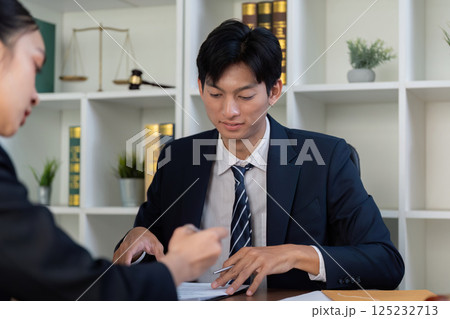 Consultation and Legal Advice. An attorney meeting with a client to review documents. Consultation and Legal Advice. An attorney meeting with a client to review documents. 125232713