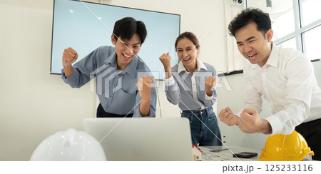 Celebration of Progress and Achievement. A team of architects and engineers cheerfully reacting to project success. 125233116