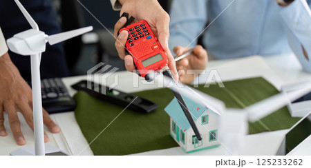 Tools for Sustainable Building Assessment. A professional demonstrating a measurement device for eco-friendly construction. 125233262