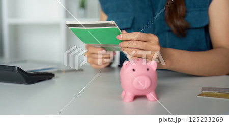 Savings Strategies and Financial Planning. A close-up of a woman handling her savings account. Savings Strategies and Financial Planning. A close-up of a woman handling her savings account. 125233269