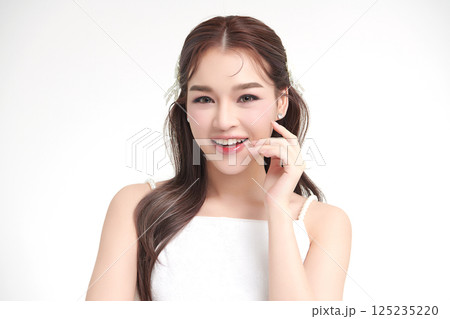 A beautiful young Asian woman with clean, fresh skin against a white background. Skincare, facial treatment, cosmetology, beauty, and spa. An elegant portrait of an Asian woman. A beautiful young Asian woman with clean, fresh skin against a white background. Skincare, facial treatment, cosmetology, beauty, and spa. An elegant portrait of an Asian woman. 125235220