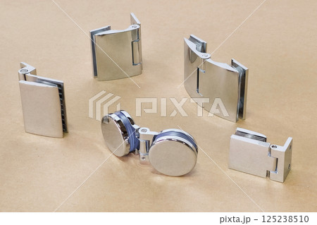 variety of chrome glass hinges are laid 125238510