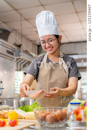 Chef preparing food ingredients  in Professional Kitchen 125239407