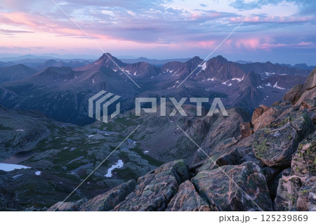The mountains are covered in snow and the sky is a beautiful pink color 125239869