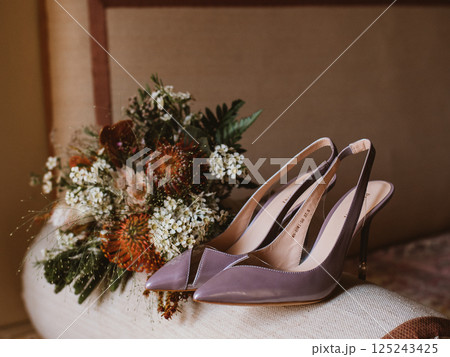 Delicate bridal bouquet and pair of elegant heels Delicate bridal bouquet and pair of elegant heels 125243425