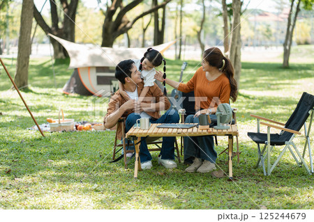 Happy asian family picnic in park, weekend lifestyle outdoors. 125244679