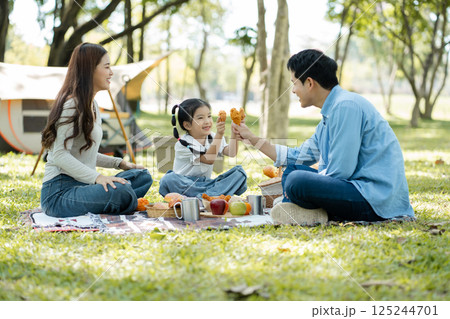 Happy asian family picnic in park, weekend lifestyle outdoors. 125244701