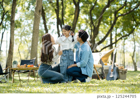 Happy asian family picnic in park, weekend lifestyle outdoors. 125244705