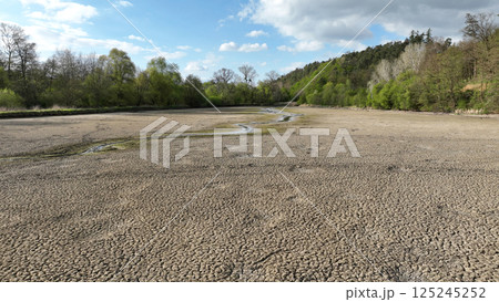 Drought pond soil cracked crust wetland water, swamp drone aerial drying up earth climate change, environmental disaster and earth cracks very, death for plants and animals, soil dry, Europe Drought pond soil cracked crust wetland water, swamp drone aerial drying up earth climate change, environmental disaster and earth cracks very, death for plants and animals, soil dry, Europe 125245252