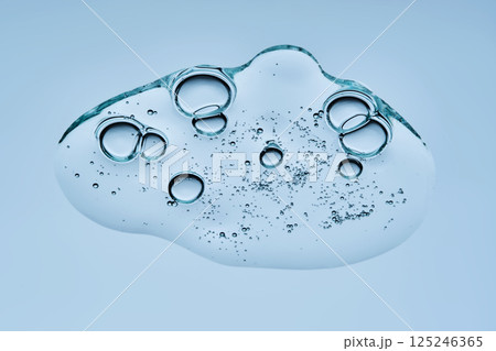 A drop of gel serum with bubbles. The texture. View from below. A drop of gel serum with bubbles. The texture. View from below. 125246365