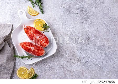 Raw uncooked salmon with rosemary Raw uncooked salmon with rosemary 125247050