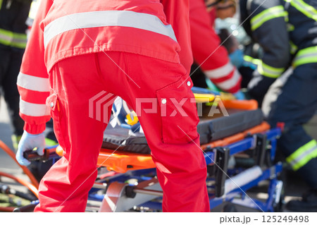Paramedics and firefighters in urgent rescue operation after road traffic accident Paramedics and firefighters in urgent rescue operation after road traffic accident 125249498
