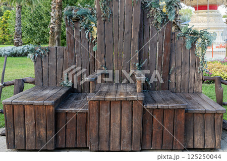 Decorative Wooden Bench With Natural Accents in a Lush Garden Setting Decorative Wooden Bench With Natural Accents in a Lush Garden Setting 125250044