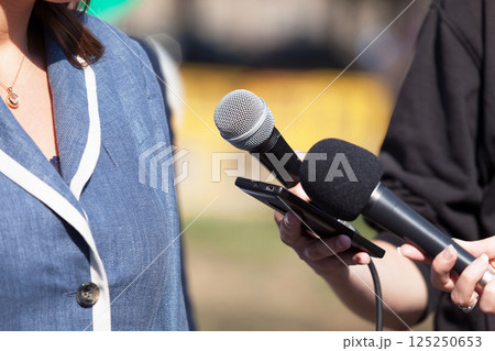 Reporters making media interview with business woman or female politician Reporters making media interview with business woman or female politician 125250653