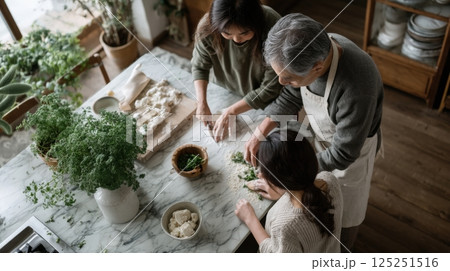 Family Cooking Together in Bright Kitchen 125251516