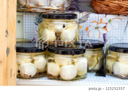 Glass jars with mozzarella balls in brine Glass jars with mozzarella balls in brine 125252357