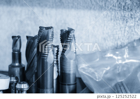 Close-up scene the used rough cutter end mill tools in the light blue scene. 125252522