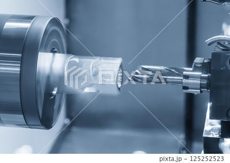 The multi tasking CNC lathe machine Swiss type hole cutting process the metal tube parts in the light blue scene. The multi tasking CNC lathe machine Swiss type hole cutting process the metal tube parts in the light blue scene. 125252523