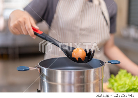 Smiling Chef Cooking with Fresh Ingredients in a Professional Kitchen Smiling Chef Cooking with Fresh Ingredients in a Professional Kitchen 125253443