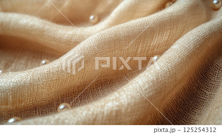 Luxury White Pearls Lying on Coarse Woven Beige Linen Background Close-Up 125254312