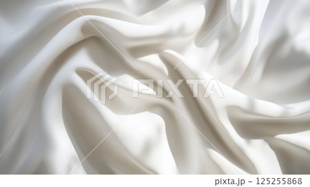 Minimal white satin drape with natural folds and highlights, abstract high-detail fabric background with soft shadows and modern clean aesthetic for elegant product display 125255868