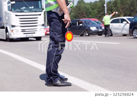 Police officer controlling traffic on the highway Police officer controlling traffic on the highway 125256824
