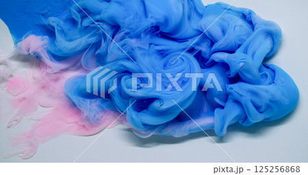 Color smoke texture. Paint water. Defocused blue pink cloud splash exhaust mix liquid flow spreading on abstract white background. 125256868