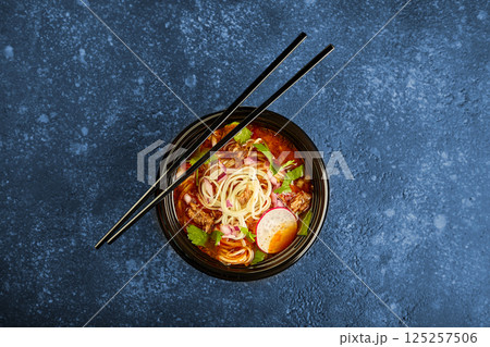 Birria ramen, consomme soup with beef and noodle. Mix of Mexican and Asian cuisine 125257506